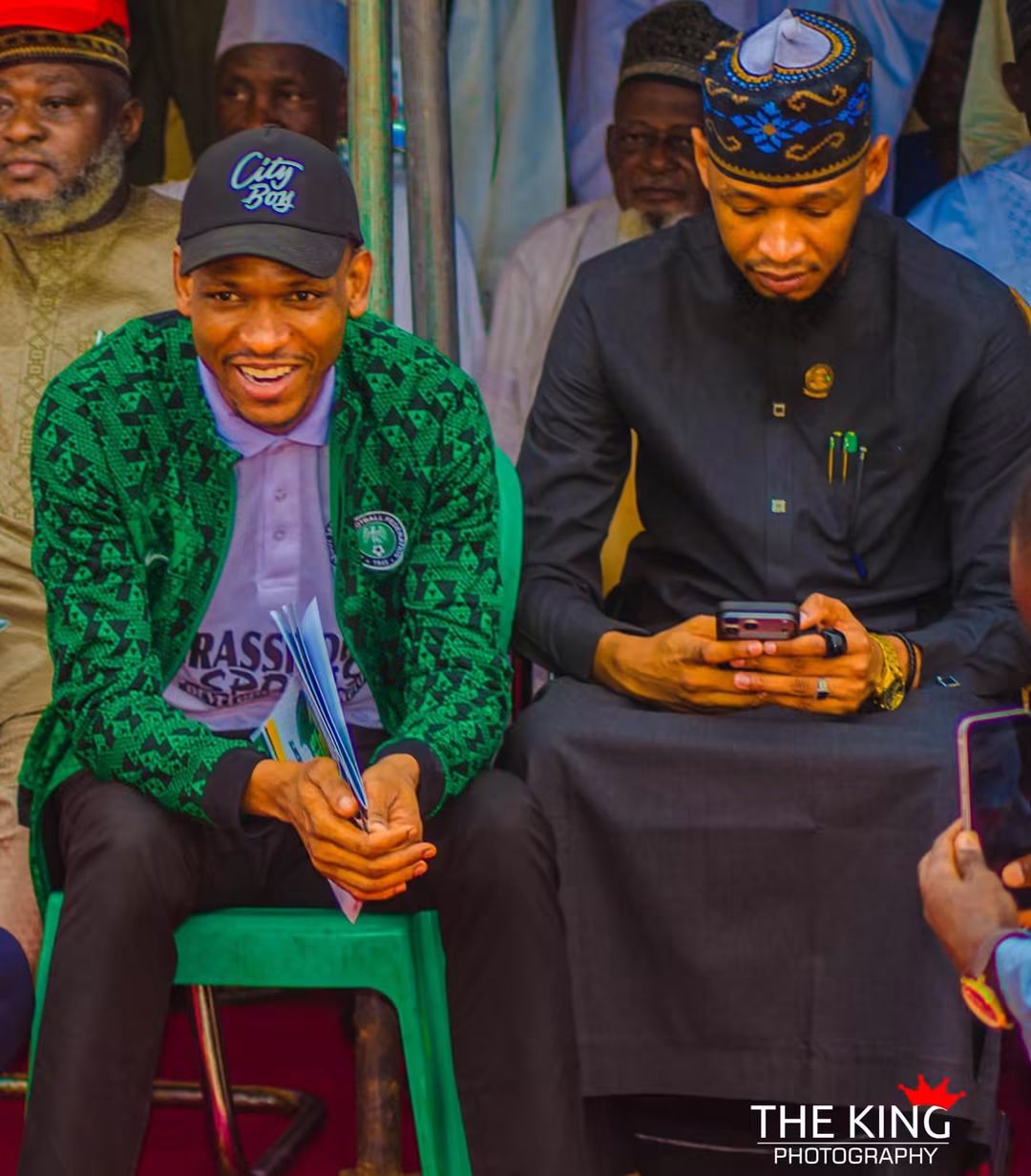 Director of Youth and Sports seated with a City Boy Movement participant